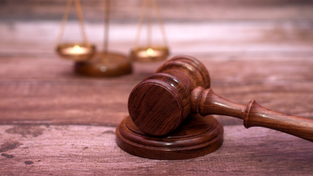 A man fired from his job after not complying to take off T-shirts with Bible verses on them has reached a settlement with the company.